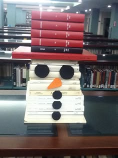 a snowman made out of books sitting on top of a table