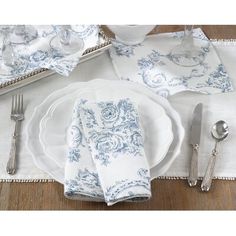 a white and blue place setting with silverware