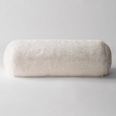 a roll of white wool sitting on top of a table