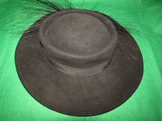 "Mr John black wool fedora style hat with 3 1/2\" wide banded brim, with flurry 5 to 6\" black feathered/ribbon bow band on one side. Possible 1950's era, with circumference of inside crown is 21\". Band is circled with wire band, so it can be shaped for your style. Hat is in very good condition. I believe the feathers are Ostrich. PRICE IS $99.00SALE FINAL/AS IS/NO RETURNS." Wide Brim Hat With Feather Trim For Fall, Fall Wide Brim Hat With Feather Trim, Formal Hat With Feather Trim, Black High Crown Hat For Fall, Formal Costume Hats With Feather Trim, Formal Costume Hats And Headpieces With Feather Trim, Kentucky Derby Brimmed Felt Hat With Feather Trim, Elegant Feathered Fedora Felt Hat, Elegant Fedora Felt Hat With Feathers