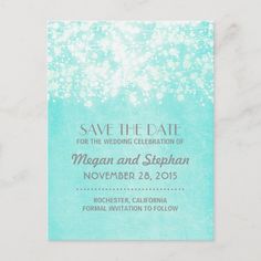 save the date card with blue watercolors and white glitter on it, in front of a marble background