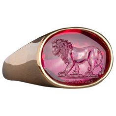 This exquisite intaglio is masterfully engraved onto man made corundum and features a lion. The intaglio is set in an 18K gold signet ring. Production time for this piece is 12-14 weeks. Can be made in any size ranging from 8-12. Chavdar Chushev is an artist, restorer, jeweler, and master of the ancient art of gem carving. His extensive knowledge of gemstones and precious metals is complimented by a familiarity with more unusual materials, such as exotic woods, organic gems, and fossils. This un