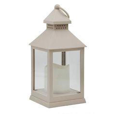 a white lantern with a candle on top