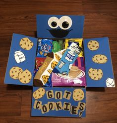 a cookie box made to look like a cookie monster with cookies and candy in it