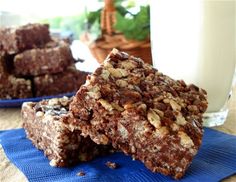 some brownies are stacked on top of each other next to a glass of milk