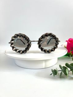 Silver spiked punk statement  sunglasses. These studded round sunglasses are simple yet make a huge statement to your outfits. The frames are light weight and they have silver mirrored lenses. All around the frames are charcoal colour studs giving them a gophic edgy look. Great for raves, festivals, carnivals, holidays or everyday wear if that's your thing 😉 UV protection. All my glasses come in a black pouch to keep them safe, please also handle with care. Checkout the full collection of Sunnies here :  https://www.etsy.com/uk/shop/AlexisExclusive?ref=s2-header-shopname ✨Find us on Instagram: https://www.instagram.com/AlexisExclusive To be kept up to date with new designs please FAVORITE MY SHOP. Adjustable Punk Sunglasses For Summer, Adjustable Punk Style Sunglasses For Summer, Punk Style Adjustable Sunglasses For Summer, Punk Sunglasses With Mirrored Lenses And Adjustable Fit, Punk Style Mirrored Sunglasses For Summer, Trendy Metal Sunglasses For Festivals, Festival Metal Sunglasses With Mirrored Lenses, Metal Sunglasses With Mirrored Lenses For Festivals, Black Metal Sunglasses For Party