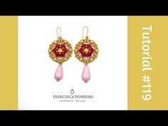 a pair of earrings with red beads and pink tears on the bottom, in gold