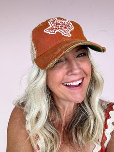 A perfect patch for a perfect state! This beautiful and fun hat features an embroidered Texas patch with floral design on a burnt orange background. Slight distressing gives this one a vintage inspired, worn-in feel that you'll love right from the start! Perfect for those Texas Longhorn fans! Handmade patch designed and made in Texas Distressed 'old favorite' style hat Snapback feature ensures a perfect fit Distressed Brown Summer Hat, Casual Brown Hat With Embroidered Patch, Distressed Brown Vintage Hat, Distressed Brown Trucker Baseball Cap, Vintage Brown Cotton Trucker Hat, Spring Orange Trucker Hat One Size, Vintage Brown Trucker Hat For Spring, Distressed Brown Snapback Trucker Hat, Brown Distressed Snapback Trucker Hat