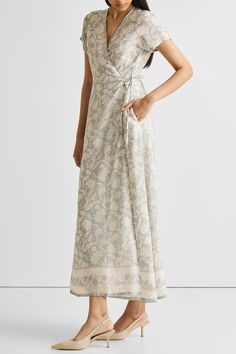 Unveil elegance with our 'Maxi Wrap Dress in Blue Florals,' featuring a relaxed fit and adorned with delicate blooms. This chic wrap dress, perfect for cool evenings or leisurely afternoons, offers both style and comfort. Embrace its versatile design, complemented by the convenience of pockets on both sides. Elevate your summer wardrobe with this trendy maxi dress, ideal for casual gatherings or a stylish day out. Wash in cold water or dry clean only Do not soak bleach or wring Line dry in shade Elegant Floral Print Wrap Maxi Dress, Elegant Floral Print Wrap Dress For Garden Party, Elegant Sleeveless Floral Print Wrap Dress, Summer Floral Print Wrap Dress For Daywear, Trendy Maxi Dresses, Vintage Bouquet, Blue Florals, Floral Wrap Dress, Wrap Dress Floral