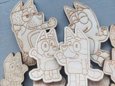 several wooden cutouts of cartoon characters on a table