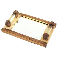 a wooden mirror frame with two handles on it