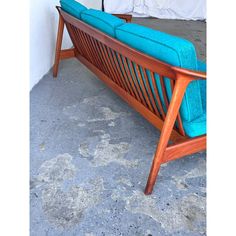 a blue couch sitting on top of a cement floor