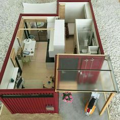 an overhead view of a small house with the living room and bedroom visible from above