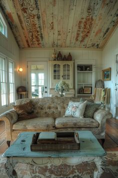 a living room filled with furniture and lots of windows