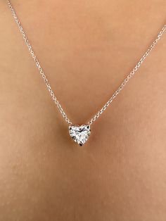 This Beautiful timeless floating diamond pendant is set with a lab-grown heart-shaped diamond in 14k solid gold. It will be the classic perfect gift for any woman in your life--whether she's your wife, girlfriend, fiancée, or bride. The photos show a 0.75ct heart-shaped lab-grown diamond. All of our diamonds are high-quality D color, VS1 clarity. Each diamond is securely set in a Prong setting, radiating sophistication with every glance. Every diamond is expertly positioned to reflect maximum light and brilliance that tells your forever love story. The pendant and chain are made of 14k solid gold and feature a spring clasp. Our collection offers a variety of sizes and carat weights to suit diverse preferences. For the heart diamond pendant Choose from diamonds ranging from 0.5 carats measu Classic Heart Cut Brilliant Diamond Necklace, Classic Brilliant Cut Heart Shaped Diamond Necklace, Classic Heart Shaped Necklace With Prong Setting, Classic Heart Cut Diamond Necklace With Prong Setting, Formal Double Heart Necklace With Brilliant Cut, Classic Heart Cut Brilliant Necklace, Classic Heart Cut Necklace With Prong Setting, Formal White Gold Heart Necklace With Vvs Clarity, Formal Diamond White Heart Necklace With Diamond Cut