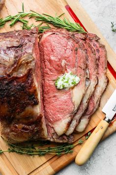 a large piece of meat sitting on top of a cutting board