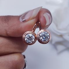 7 MM Round Cut White Moissanite Solitaire Daily Wear Earrings Set, Bezel Set Brilliant Diamond Drop Leverback Rose Gold Women Earrings Gift  ❤Custom Order Always Welcome❤ STONE DETAILS Gem Type: Moissanite Center Stone: Moissanite Stone Shape: Round Cut Stone Color: White Colorless Clarity: VVS1 Stone Wight: 2.20 Ct (Approx) (Side Stone Included) Guarantee: Test Positive & Life time Brilliance Main Stone Creation: Lab Created Durability: Tougher Than Diamond Impervious To Heat & Chemical EARRING DETAILS Metal Color : As Per Picture Metal Purity : 14k Rose Gold Style : Stud MOISSANITE DESCRIPTION Description : Moissanite Diamond Refractive Index : 2.65-2.69 2.42 Dispersion : 0.104 0.044 Luster : 20.40% 17.20% Hardness (Mohs Scale) : 9.25 10 Toughness : Excellent Excellent PAYMENT We accept Rose Gold Round Cut Earrings For Formal Occasions, Rose Gold Bridal Earrings With Halo Design, Rose Gold Round Halo Bridal Earrings, Classic Rose Gold Round Bridal Earrings, Formal Rose Gold Round Cut Earrings, Diamond White Channel Set Diamond Earrings As Gift, Round Moissanite Earrings With Halo Design, Moissanite Halo Design Earrings, Classic Rose Gold Bridal Earrings With Prong Setting