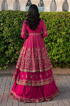 Shocking Pink Pakistani Wedding Dress Double Layered Frock with Lehenga comes with Pakistani raw silk tunic which is embellished with embroidered borders and sequins. There is a richly embroidered dupatta which has sequin work on it. Detailed Description: SKU: WB420 Detailing: Embroidery, Motifs, Naqshi, Sequins, Tilla Color: Shocking Pink Fabric: Net, Tissue, Cotton Silk Design: Fully Embellished Dress with Embroidery, Goldwork Event: Bridal wear, Wedding Embroidered Embellished Dress For Wedding And Diwali, Anarkali Embroidered Dress With Dupatta For Wedding, Embroidered Dress For Wedding Diwali, Wedding Anarkali Embroidered Georgette Dress, Bollywood Style Embellished Chinon Dress, Traditional Embellished Embroidered Dress For Reception, Embroidered Embellished Dress For Wedding, Embroidered Georgette Dress With Dupatta For Wedding, Wedding Embroidered Georgette Dress With Dupatta