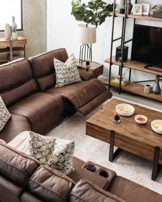 a living room filled with furniture and a flat screen tv sitting on top of a wooden table