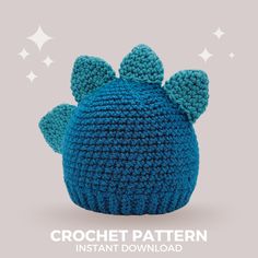 a crocheted blue hat with ears on the side and stars in the background