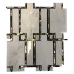 a white marble and metal mosaic tile with squares in the shape of rectangles