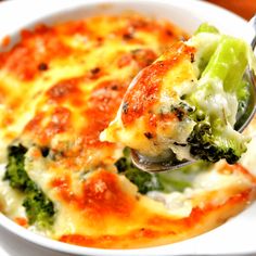 broccoli and cheese casserole with a spoon in it