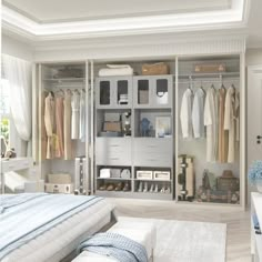 an organized bedroom with white closets and drawers