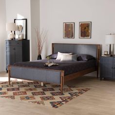 a bed sitting on top of a wooden floor next to a dresser