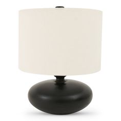 a black table lamp with a white shade on the top and bottom part of it