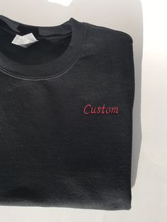 This listing is for a custom embroidered UNISEX crewneck sweatshirt. The more text you add the smaller the text will be. Interested in a different sweatshirt color, thread color, font, etc? Message us on Etsy to make a request. Please see the size chart in the product listing photos to determine the best size for you. Custom embroidered sweatshirts make a gift for any occasion - anniversary, bachelor party, bachelorette party, back to school, birthday, engagement, graduation, sweet 16's and quinceañera's, retirement, and weddings. They're also perfect for any holiday because this sweatshirt is customizable - Valentine's Day, St. Patrick's Day, Easter, Mother's Day, Father's Day, Halloween, Thanksgiving, Hanukkah, Christmas, and more. Or this could be a wonderful treat for yourself. These s Black Cotton T-shirt With Letter Embroidery, Crew Neck T-shirt With Custom Embroidery, Black Cotton T-shirt With Custom Embroidery, Black Crew Sweatshirt With Embroidered Graphics, Custom Text Long Sleeve Sweatshirt As A Gift, Black Letter Embroidery T-shirt For Streetwear, Black Crew Neck Top With Letter Embroidery, Custom Text Crew Neck T-shirt For Gift, Black Crew Neck Sweatshirt With Letter Embroidery