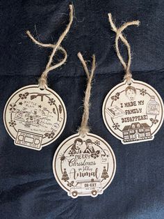 three wooden christmas ornaments hanging from twine