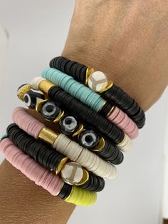 "This listing is for TWO bracelets. The bracelets are made with African clay discs and gold accent beads. My hand-beaded bracelets are made with stretch elastic which makes it comfortable and easy to wear. My bracelets are made to fit an average wrist size of 6.5\"-7\". Take a look around my shop for additional colors to add to your stack! The more the better! I've included pictures to give you an idea of bracelets to add to your set." Adjustable Stackable Rondelle Bracelets, Stackable Heishi Beads Bracelets, Adjustable Stacked Beaded Bracelets With Round Beads, Adjustable Stacked Round Beaded Bracelets, Adjustable Stackable Rondelle Stretch Bracelet, Adjustable Stackable Stretch Bracelet With Round Beads, Adjustable Spiritual Heishi Bead Bracelet, Adjustable Stackable Stretch Bracelet, Adjustable Stacked Heishi Beads Stretch Bracelet