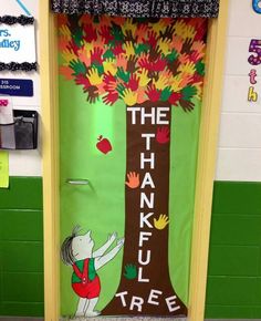 a classroom door decorated with an image of a tree and the words, the thank tree