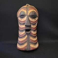 Authentic African Hand Carved Natural Finish Wooden Mask Representing The Songe Tribe. No Provenance To Support Age. Imported. Approximately 15"H, 8"W, 4"D. The Songye People, Sometimes Written Songe, Are A Bantu Ethnic Group From The Central Democratic Republic Of The Congo. They Inhabit A Vast Territory Between The Sankuru And Lubilash Rivers In The West And The Lualaba River In The East. Wooden Mask, Democratic Republic Of The Congo, African Mask, African Masks, Republic Of The Congo, Hand Carved, Carving, Mask