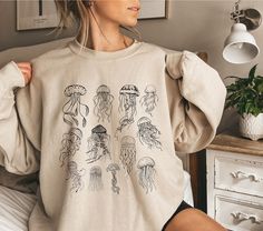 This jellyfish sweater with a jellyfish print is perfect for an ocean inspired style and summer sweatshirt for animal, marine life, sea and nature lovers. It's a great gift for marine biologists. Also available as T-Shirt: https://wandercraftsdesign.etsy.com/listing/1728681053/save-the-ocean-inspired-style-jellyfish ♥PRODUCTION TIME: 1-5 days (usually 2-3 days) ♥SHIPPING TIME: 2-5 days in USA (Usually 2-3 days). International shipping takes longer. ♥PRODUCT DESCRIPTION: Gildan 18000 Unisex Sweat Jellyfish Sweater, Appropriate Costumes, Work Appropriate Costumes, Shark Oc, Jellyfish Shirt, Sweater Print, Jellyfish Print, Save The Ocean, Summer Sweatshirt