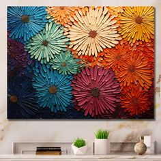 an abstract painting with colorful flowers on the wall in front of a white fireplace mantel