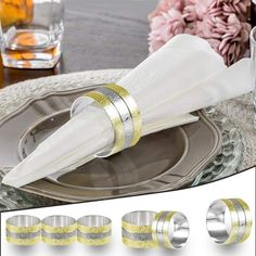 silver and gold colored napkins are sitting on a plate next to some glassware