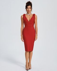 a woman in a red dress is posing for the camera with her hands on her hips