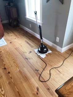 a hardwood floor is being cleaned with a steam mop in the middle of it