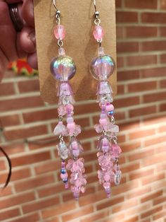 Named after the Pink Meanie jellyfish species, these pretty pink earrings will probably make your sea-loving friends pretty jelly! These earrings come with a heap of acrylic beads, some glass beads, and a few small pieces of rose quartz! They also have quite the lovely jingle to them when they're swinging to and fro. Length of earring is about 5 inches and weight per earring is about 0.275 oz* *measurements of drop length and weight are imprecise and should not be taken as a strict guarantee Cute Pink Dangle Beaded Earrings, Cute Pink Beaded Dangle Earrings, Pink Beaded Earrings With Round Beads For Pierced Ears, Pink Beaded Crystal Drop Earrings, Pink Beaded Drop Crystal Earrings, Whimsical Pink Beaded Earrings, Handmade Pink Crystal Dangle Earrings, Whimsical Pink Dangle Earrings, Pink Beaded Resin Jewelry