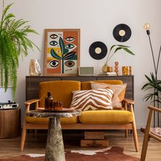 a living room filled with furniture and plants