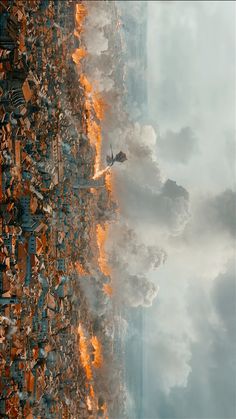 an aerial view of the sky and clouds with fire coming out of it's sides