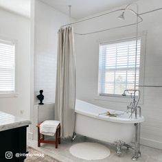 a white bathroom with a claw foot tub