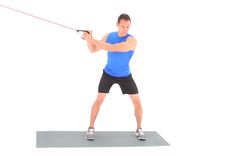 a man is using a rope to pull his body up on a balance mat with one hand