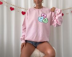 Celebrate Valentine's Day with our sweet and cozy Conversation Hearts Sweatshirt. A lovable Valentine classic with a trendy modern design. Makes great gifts for all your girlfriends too!  Conversation Hearts Sweater, Candy Hearts, Valentines Day Shirt, Valentines Conversation Heart, Retro Style V-Day, Fun Cute Crewneck A sturdy and warm sweatshirt bound to keep you warm in the colder months. A pre-shrunk, classic fit sweater that's made with air-jet spun yarn for a soft feel and reduced pilling. Sweater Candy, Heart Retro, Hearts Valentines Day, Cute Crewneck, Hearts Valentines, Conversation Heart, Conversation Hearts, Candy Hearts