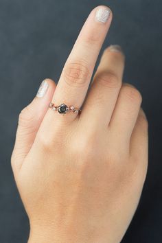 a woman's hand with a diamond ring on it