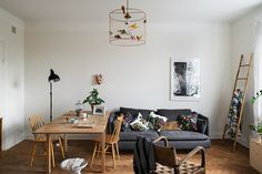 a living room filled with furniture and a wooden table in front of a large window