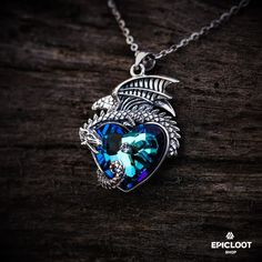 925 Silver Dragon guards a blue crystal heart necklace. – Epic Loot Shop Sterling Silver Spiritual Necklace With Dragon Design, Spiritual Sterling Silver Necklace With Dragon Design, Blue Spiritual Heart Pendant Jewelry, Spiritual Blue Heart Pendant Jewelry, Spiritual Blue Heart Pendant Necklace, Blue Mystical Pendant Jewelry, Mystical Blue Pendant Jewelry, Mystical Blue Pendant Necklace, Blue Heart-shaped Spiritual Necklace