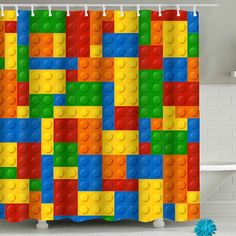 a shower curtain with lego blocks on it in a bathroom next to a bathtub