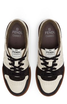 The iconic double-F logo makes a low-key appearance on a court-inspired sneaker set in a two-tone cupsole embossed with logo lettering. Lace-up style Leather upper and lining/rubber sole Removable insole Made in Italy Men's Shoes Brown Sporty Sneakers With Logo, Sporty Brown Sneakers With Logo, Luxury Streetwear Sneakers With Gum Sole, Designer Low-top Sneakers With Gum Sole, Sneaker Men, Low Key, Up Styles, Rubber Sole, Two Tone